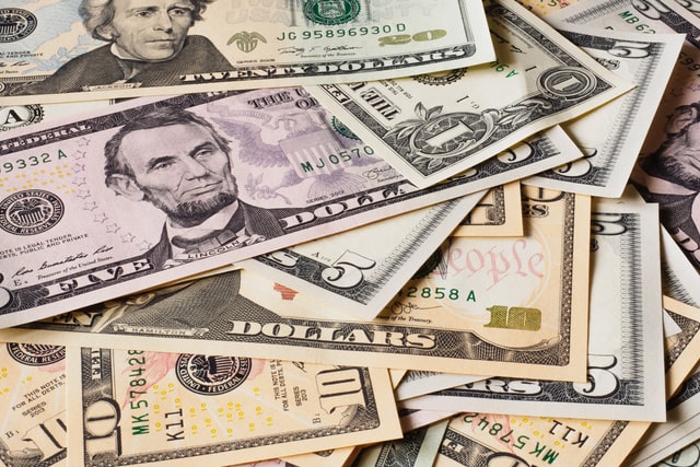 une pile de billet de différentes monnaies symbolisant l'économie mondialisée